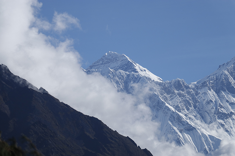 Clouds seen in between two huge mountains 