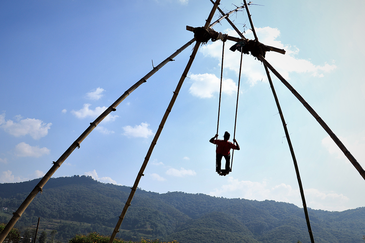 A boy enjoying swing on the ocassion of Dashain