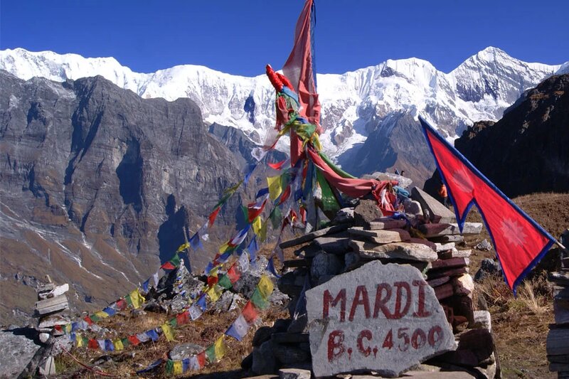 sign of "MARDI" at mardi base camp with a view of mounatin behind