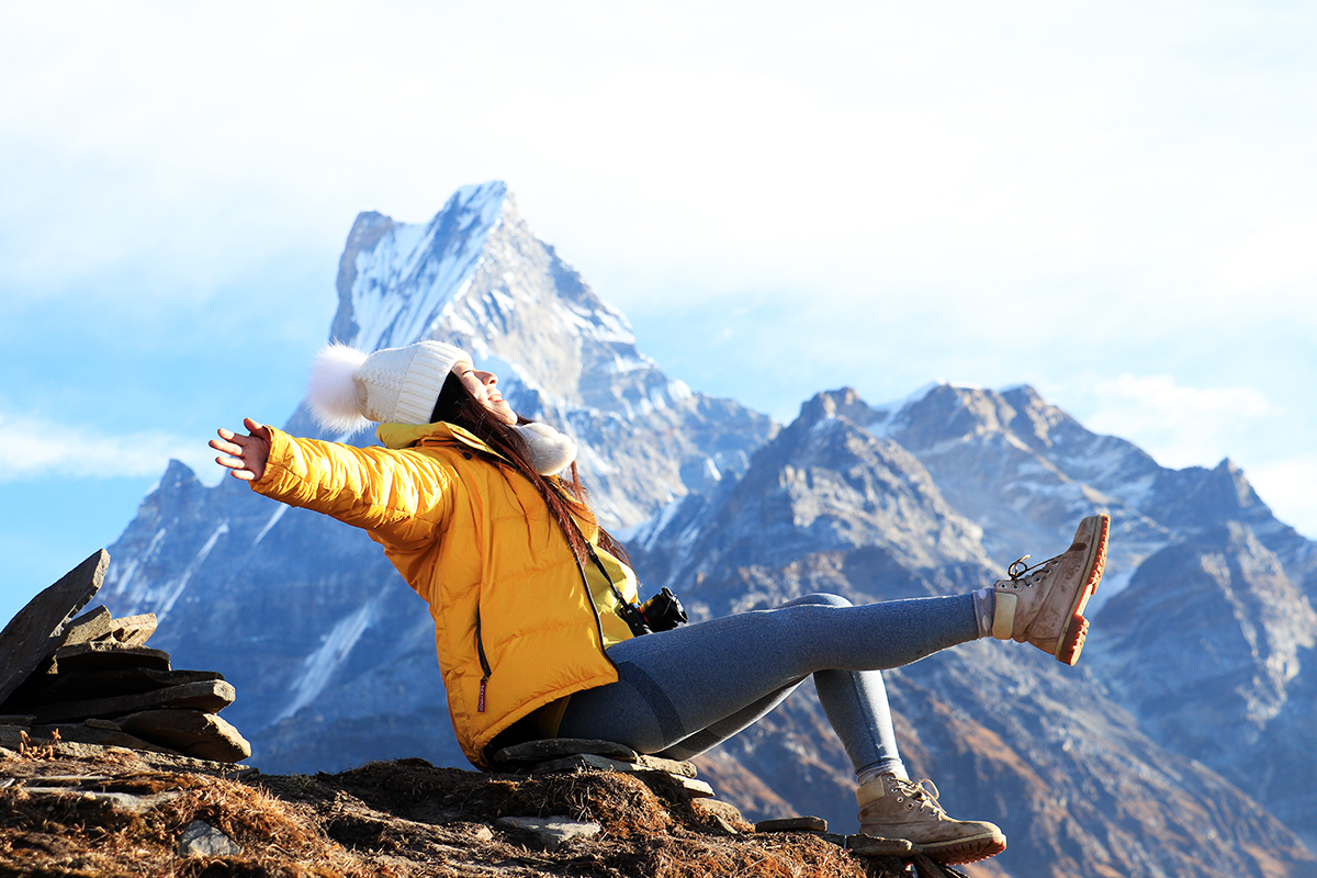 girl on yellow jacket enjoying the nature in himalayas