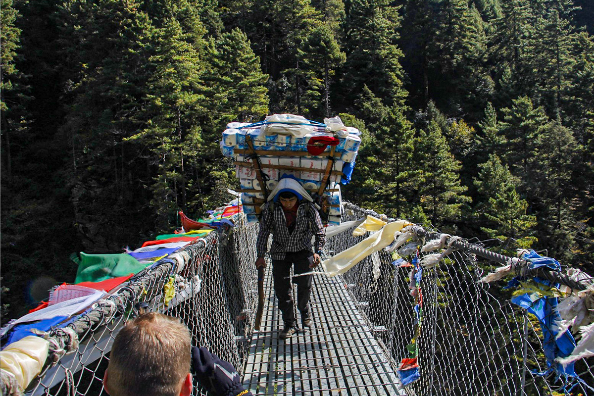 Everest Porter Carrying Heavy Load at Hillary Bridge
